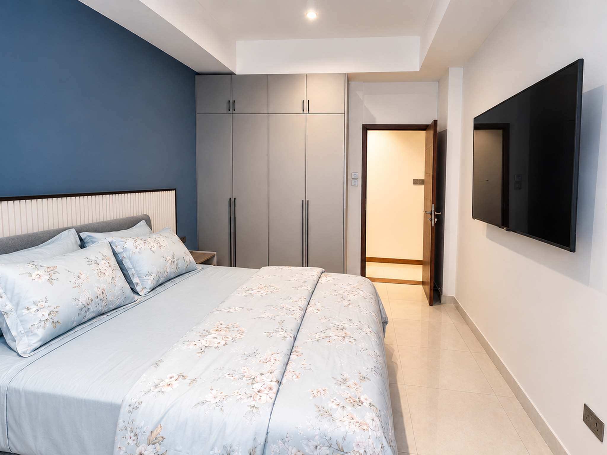 Bedroom with TV and wardrobe